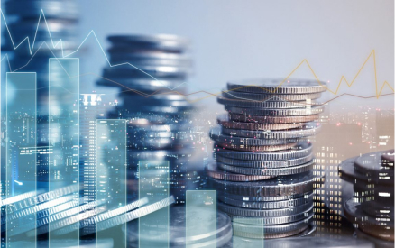 A digital collage showing stacks of coins superimposed on a cityscape at night. Overlaid are financial graphs with fluctuating lines, representing economic trends and market analysis.