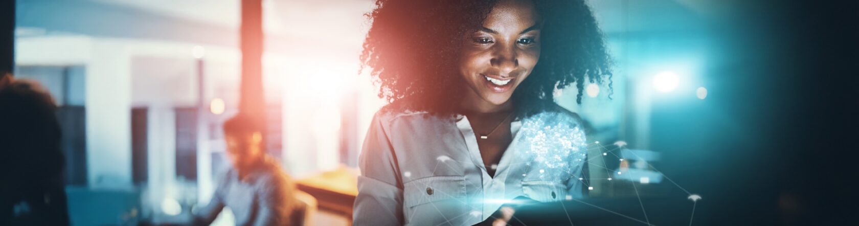 A woman is smiling as she looks at a glowing tablet, surrounded by digital network graphics. The background is blurred, giving a sense of a modern office environment.