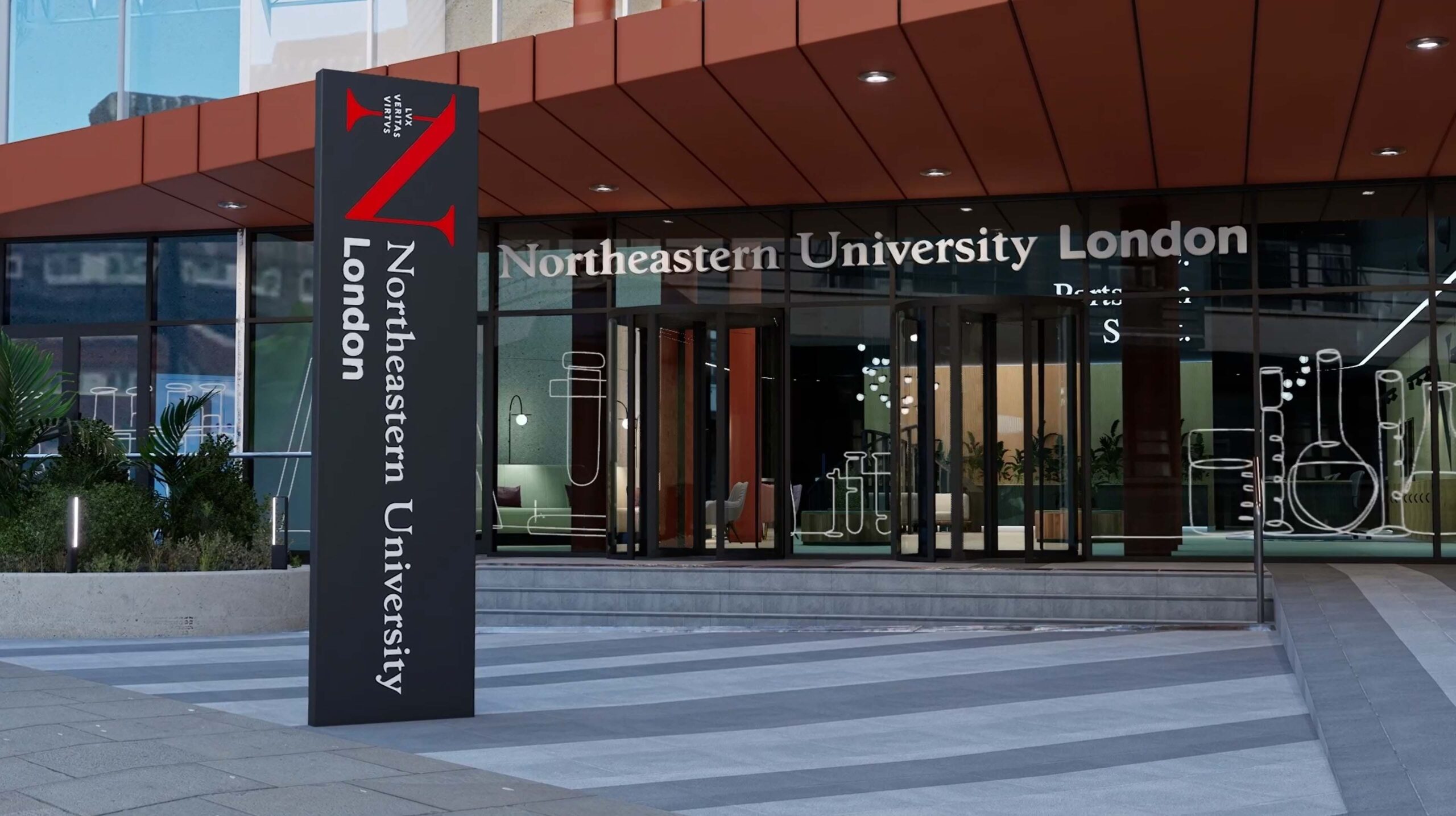 Modern building entrance with large windows and a sign reading "Northeastern University London" in white text on a black background. Pathway with gray tiles leads to the entrance, which has red-orange accents above.